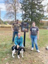 From left: volunteer Joe Dorrough; Library Director, Rose Chiocchi; Molly the dog; and volunteer Michael Smith
