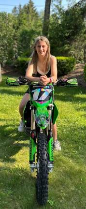 Girls on the field, ice, mat West Milford’s Ella Hammett is all smiles on her Kawasaki KX112 super minibike. (Photo provided)