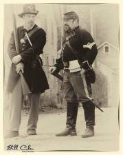 A photo of two solders dressed in Civil War-era garb.