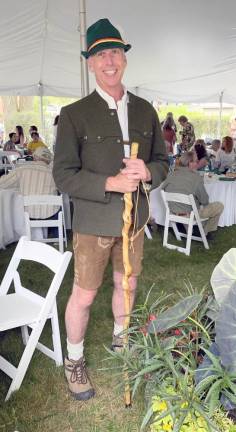 Dr. Doug Manion, in great spirits and equally great hiking attire, celebrating the party’s theme, “All Trails Lead to Milford” (Photo by Marilyn Rosenthal)