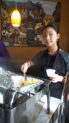 Cooks and tasters agree: Everybody wins Volunteers served the comfort food with a smile and a reminder to vote for the top three winners in each category. (Photo by Frances Ruth Harris)