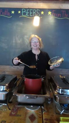 Mac 'n cheese in wonderland Lori Strelecki serving her creation (Photo by Frances Ruth Harris)
