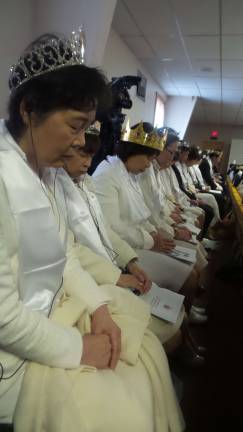 Gun-wielding couples renew their vows Women wore white, and most parishioners wore crowns (Photo by Frances Ruth Harris)