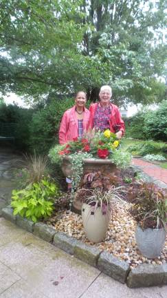 Secret gardens, revealed Garden Club members Jenny Dye and Ruth Boudreaux meet at Remembrance Place (Photo by Frances Ruth Harris)