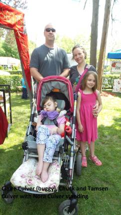 Food, music, and purring alpacas Claire Culver (in buggy), Chuck and Tamsen Culver with Nora Culver (standing)