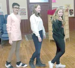 Before a rehearsal are (from left) Tim Cortes, Taylor Mieszkuc, and Mia Mesnick doing their version of the Abbey Road cover.