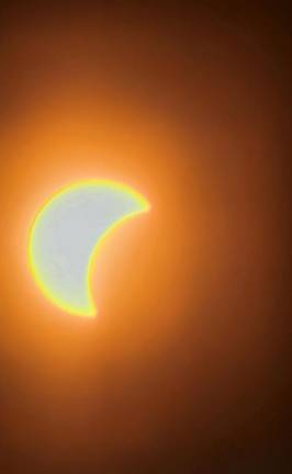 The moon covers part of the sun Monday afternoon, April 8, as seen from the Wallkill River National Wildlife Refuge in Sussex. (Photo by Gulbadan Habibi)