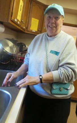Carolyn Susanowicz has washed dishes after dinners for four years. China plates are used for the main entrees. (Photo by Frances Ruth Harris)