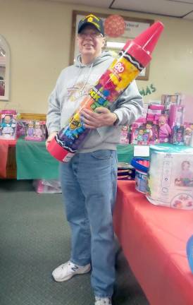 DJ Knight stands ready with a giant crayon filled with building blocks. (Photo by Frances Ruth Harris)