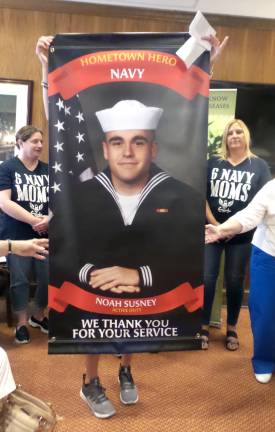 Missy Susney and Tammy Savarese with a banner honoring Noah Susney.