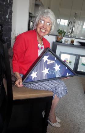 I got a flag! Denise Smithson cherishes the flag that covered the casket of her husband Nick Caputo, who served in the Navy.