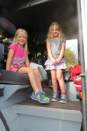 Put fire safety first DVES students Lydia Boronow and Nicole Helt get a tour of a fire truck (Photo by Peg Snure)