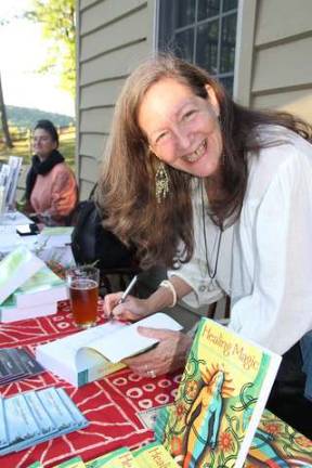 Community embraces Kitchen Garden Tour Robin Rose Bennett signing her book "Healing Magic."