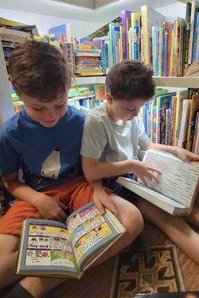 Searching for a library <b>Rowan and Isaac Martens reading at home in Minisink, N.Y. The Martens were the first in their town to sign up for a Port Jervis, N.Y., library card, but because it’s a 19-minute drive, they rarely get there. Now, with newly limited access, it becomes still less convenient, but they plan to make the effort to go this summer. ‘I want my kids to have the library experience,’ Melissa Martens said, ‘even if it’s not convenient.’ (Photo by Melissa Martens)</b>