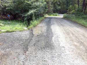 This photo shows the road damage in front of Virginia Pfeiffer’s house in Sagamore Estates last year, caused by a leak that was allowed to run for over a month (Photo provided)