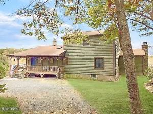 Custom three-bedroom on secluded, historic acre with lake rights