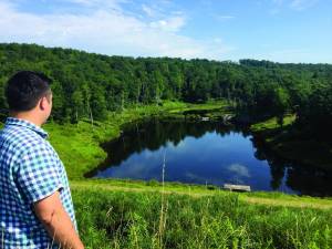 Adam Schellhammer, district manager of Monroe County Conservation District, surveys the pond created by the dry dam. He thinks this is one of “the most beautiful places in the county.”