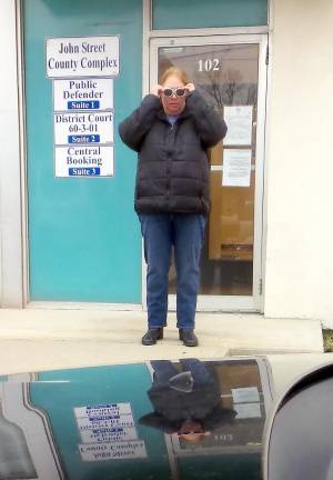 Lori Strelecki adjusts her sunglasses as she emerges from the John Street County Complex in Milford (Photo by Frances Ruth Harris)