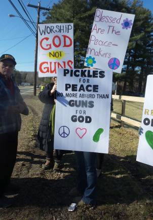 Gun-wielding couples renew their vows Protestors outside the church (Photo by Frances Ruth Harris)