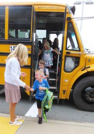 Mrs. Paige Padgett greets students off the bus.