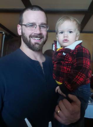 Cooks and tasters agree: Everybody wins Eric Jakubowski with his son Liam, ready to taste at what is now a yearly event for them. (Photo by Frances Ruth Harris)