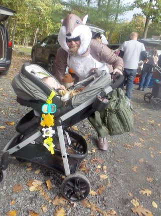 An interesting woodland creature pushes a stroller at the festivities (Photo by Frances Ruth Harris)