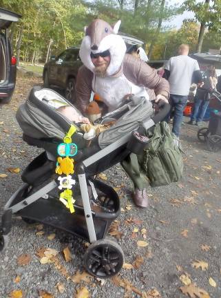 Fairy princesses mingle with ghastly ghouls at Trunk or Treat An interesting woodland creature pushes a stroller at the festivities (Photo by Frances Ruth Harris)