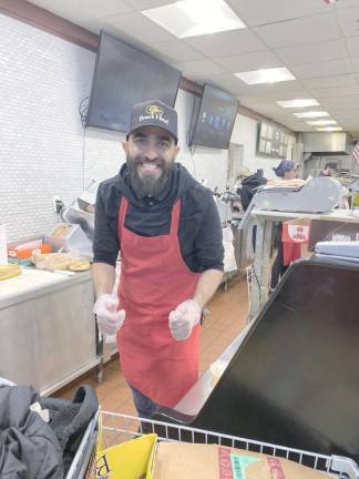 Junior Dabashi behind the deli counter at Key Foods,