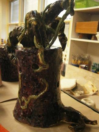 From a lump of clay come many stories Tree outgrowing container by Abbey McFeely