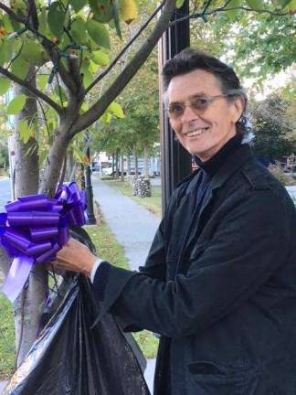 'Martinis and Manicures' get-togethers help local causes Bob Keiber of Black Bear Film Festival helps cover the town with purple for domestic violence awareness. (Photo provided)