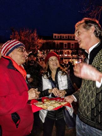 Santa arrives, the tree lights up, and all is well in Milford Milford Boro Mayor Sean Strub went around with a cookie tray and chatted with residents (Photo by Anya Tikka)