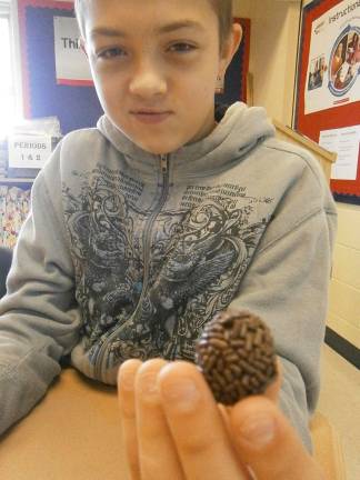 Mom shares story of immigration to America Hunter Babcock with his brigadeiro treat (Photo provided)