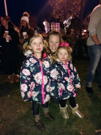 Santa arrives, the tree lights up, and all is well in Milford Lynne, 4, and Jessica, 2, came with mom Jodi Kresse to get into the holiday spirit (Photo by Anya Tikka)