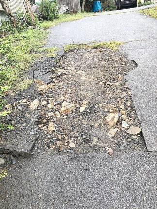 The water pipe that runs under the driveway at the home of Arona Kohn and Alexander J. Takacs III has been repaired many times, but the pavement is never restored (Photo provided)