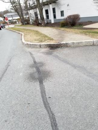 Oil stain leading to the tree in front of NBT Bank (Photo by Ken Hubeny Sr.)