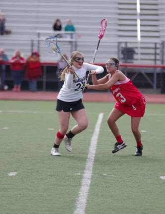 DVH Warriors defeat Hazleton Cougars in Girls Varsity Lacrosse Delaware Valley Warrior Emily Gelormino carries the ball while confronted by Hazleton Cougar Victoria Middleton