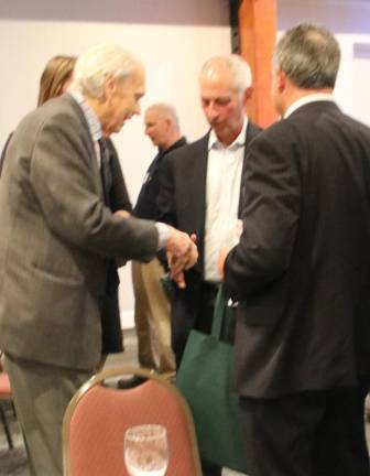 Mark Schiffer, Senior Vice President of Strategic Alliances for Northwell Health, second from left, chats with realtor Davis Chant, left.