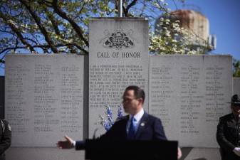 Pennsylvania Gov. Josh Shapiro speaks with the community at the memorial ceremony at the Pennsylvania State Police Academy in Hershey held Saturday in conjunction with the department’s 118th anniversary. The Memorial Wall behind the governor carries the names of all 103 troopers who have died in the line of duty. Photos provided by PAcast.