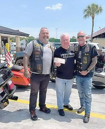 Vetstock co-founder Tom Ryan and Combat Veterans Motorcycle Association representatives at the donation presentation (Photo provided)