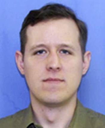 This undated PennDOT identification photo released Tuesday, Sept. 16, 2014, by the Pennsylvania State Police shows Eric Matthew Frein, 31, of Canadensis, Penn., being sought in Friday's shooting that left one trooper dead and another critically wounded at a state police barracks in Blooming Grove. A gunman killed Cpl. Bryon Dickson, 38, and critically wounded Trooper Alex Douglass outside the barracks during a late-night shift change, then slipped away. (AP Photo/PennDOT via Pennsylvania State Police)