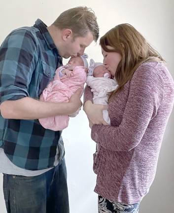 Identical twins Rebekah Faith and Charlotte Grace, with Courtney and Ken Smith, were reunited on April 18 (Photo provided)