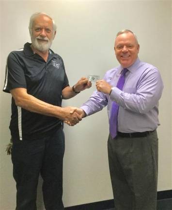 Delaware Valley School District Superintendent Dr. John Bell gives the first Senior Warrior card to Paul Gavoille, a 1970 DV graduate of DV and a member of the district's maintenance staff for more than 31 years.
