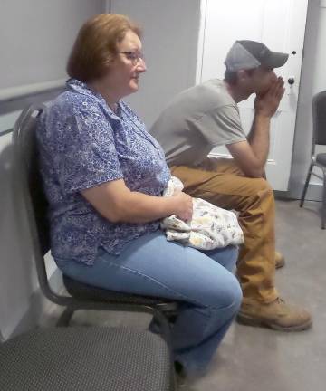 Janet Heim sat in the rear of the room for about 15 minutes before she walking to the front of the room to angrily confront the board (Photo by Frances Ruth Harris)