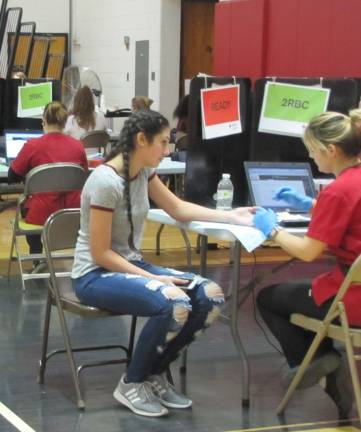 Saving lives: 94 pints collected at school blood drive DVHS Junior Natalia Torres donates at the Jan. 24 blood drive (Photo provided)