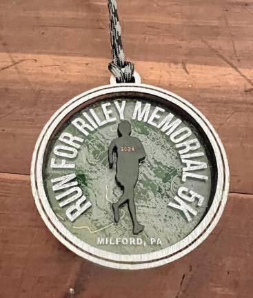 Hundreds turn out for Run for Riley memorial 5K The finisher medal received by race runners.