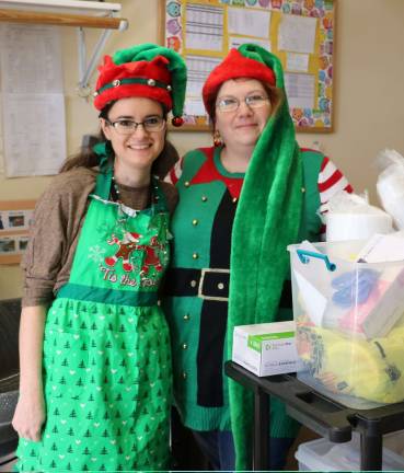 Elf-dieticians help children at CDD decorate gingerbread cookies Dietician Marisa Elliott (left) and Sous Chef Allison Wharton of the Morrison Healthcare Food Service dietary staff at Bon Secours Community Hospital (Photo provided)