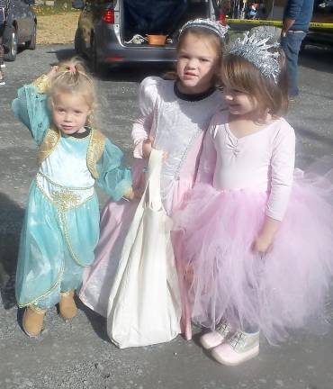 Fairy princesses mingle with ghastly ghouls at Trunk or Treat Three princesses find their way to the trunks for treats (Photo by Frances Ruth Harris)