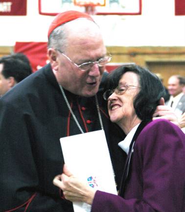 Cardinal Timothy Dolan with a parishioner during a 2012 visit to Sacred Heart Church in Monroe.