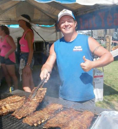 The pitmaster grilling ribs (Photo by Russ Mensch)