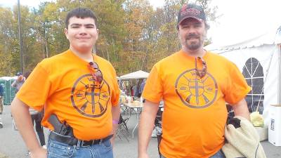 Nicholas Mele and his dad, Lou, are wearing shirts given to them by Kahr Arms.
